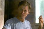 Viggo Mortensen as Eddie listens to Gwen while cleaning the stable.