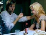 Clay loves magic tricks. Here he pulls a feather from behind Callie's ear. (Viggo Mortensen, Ashley Judd)
