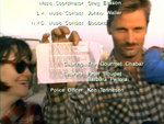 Exene Cervenka on the left, Viggo Mortensen on the right holding up a piece of paper with illegible writing on it. It's during a cast singalong of "Nothing Funny 'Bout Peace, Love and Understanding."